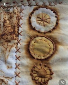 an old piece of cloth has been stitched together with stitches and threads on it