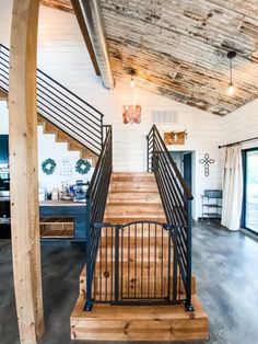 a wooden stair case with metal handrails in a home