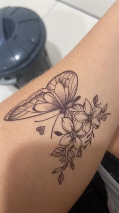 a woman's arm with flowers and a butterfly on it