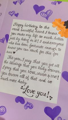 a handwritten birthday card with hearts and flowers on purple paper, featuring an orange teddy bear