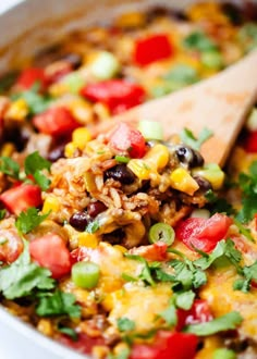 a wooden spoon full of mexican rice salad