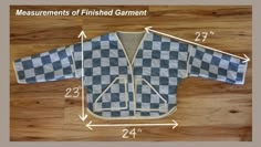 the measurements of finished garment are displayed on a wooden surface with an arrow pointing to it