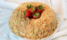 a cake covered in crumbs with strawberries on top