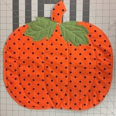 an orange pumpkin with black dots on it