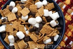 a bowl filled with marshmallows and chocolate chips on top of a table