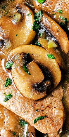 some meat and mushrooms are cooking in a skillet on the stove with green herbs