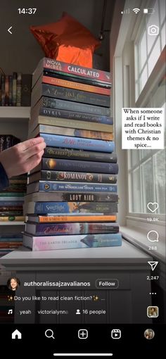 a stack of books sitting on top of a window sill next to a book shelf