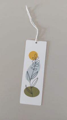 a tag with a plant on it hanging from a string