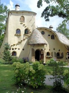 an unusual house in the middle of a garden