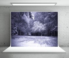 an empty room with a white brick wall and black and white photograph on the wall