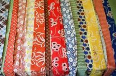 a bunch of different colored ties are lined up on top of each other in rows