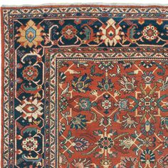 an antique persian rug with blue, red and orange colors on the border is shown