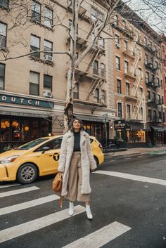 a woman standing in the middle of an intersection