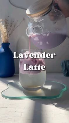 a person pouring liquid into a glass jar with the words lavender latte in it