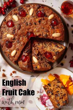 an english fruit cake with cranberries and almonds on the top is cut into slices