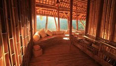 the inside of a bamboo hut with wood flooring and wooden benches on each side