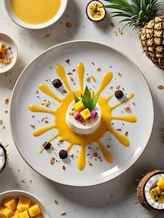 a white plate topped with fruit covered in yellow sauce and garnished with pineapple slices