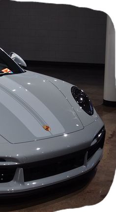 a silver sports car parked in a garage