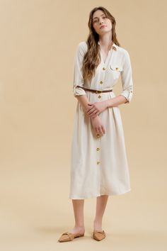 Get ready to stand out in the Monica Midi Dress, featuring a collared neckline and button down front. With gold buttons and hardware, this dress comes complete with a belted waist and pintuck details for a flattering silhouette. The long sleeves with cuff and tab detail, along with the midi length, make this a versatile shirt dress for any occasion. Plus, it even has pockets for added convenience! Yellow Gifts, Maxi Romper, Outerwear Vest, Eyelet Dress, Coral Blue, Leather Dresses, Maxi Dress Party, White Maxi Dresses, Gold Buttons