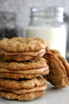 a stack of cookies next to a glass of milk