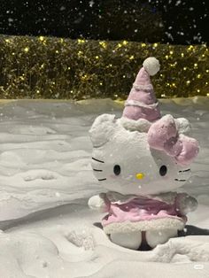 a hello kitty stuffed animal sitting in the snow