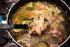 a pot filled with pasta and vegetables on top of a stove