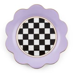 a purple and black plate with a checkerboard design on the center, against a white background