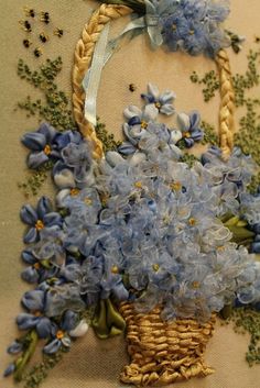 blue flowers in a basket on a table