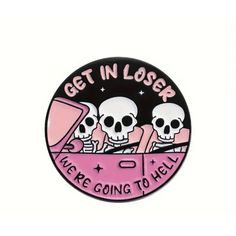 a pink and black pin with three skulls sitting in a car that says get in loss we're going to hell