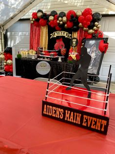 a wrestling ring is set up for an event with balloons and decorations on the walls