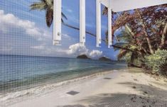 an image of a beach with palm trees and blue sky in the background, as seen from inside a building