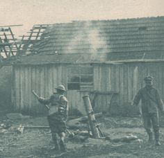 two men standing in front of a building with a roof that has been torn down