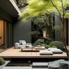 a living room with a couch, table and trees in the backround area