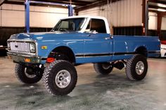 a large blue truck parked in a garage