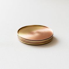 three gold plates stacked on top of each other