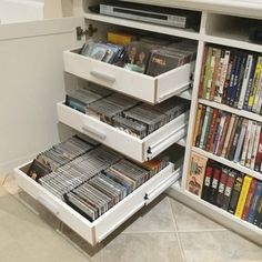 a white cabinet filled with dvd's and movies