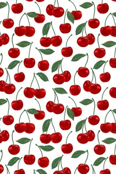 a white background with red cherries and green leaves on the top one is very large