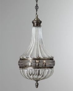 a glass chandelier hanging from a ceiling