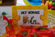 there is a sign that says pet worms in front of some gummy candies