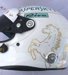 a white helmet with a horse on it's side and the words aspenky ride written in gold ink