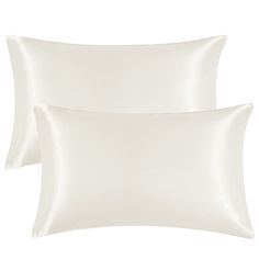 two white pillows sitting next to each other on top of a pillow case, one is plain and the other is plain