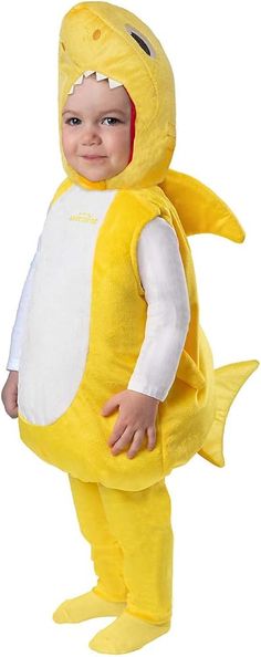 a baby dressed in a yellow shark costume