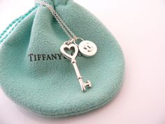 Overview:Offered for sale is a fantastic, very elegant, and super pretty Tiffany and Co. Silver Round Locks / Key Hole and Heart Key charms Combination Necklace. Wonderful necklace that fits a lifestyle on the go -- the necklace can be worn to almost any occasion! Hanging from its super pretty Tiffany & Co. sterling silver curb chain are two gorgeous and classic Tiffany & Co Charms - A Heart Key charm and a Silver Round Locks Key Hole pendant - awesome and versatile statement pieces! You can wea