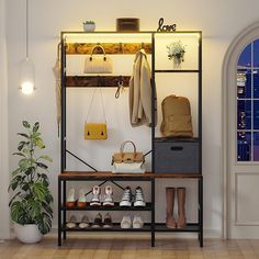 an open closet with shoes, purses and handbags hanging on the wall next to a potted plant