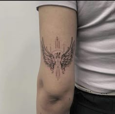 a person with a tattoo on their arm and an arrow in the middle of it