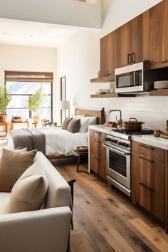 a living room filled with furniture next to a kitchen