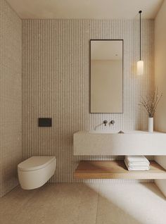 a bathroom with a toilet, sink and mirror on the wall next to each other