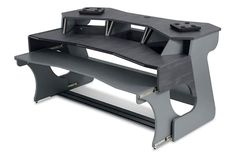 a computer desk with two video game controllers on it's top and bottom shelf