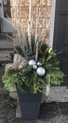 a basket filled with christmas decorations on the front steps