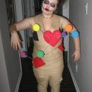 a woman dressed up in a costume with paper hearts on it